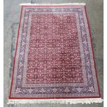 Rug / Carpet : a 20 thC Belgian Wilton rug with wine ground and 3 band borders,