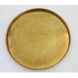 A 19thC circular brass Chinese dish with chapter ring of Chinese symbols and foliage with 7