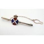 A silver tie clip with enamel decorated emblem to centre CSSG surmounted by a crown.