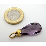 A facet cut amethyst drop pendant with yellow metal mounts approx 1 1/2" long CONDITION: