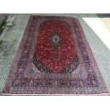 Carpet / Rug : a Persian hand made woollen carpet having wine red center ground decorative