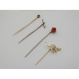 Assorted stick pins to include a yellow metal stick pin surmounted by a ruby,