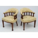 A pair of late 19thC oak upholstered bow back chairs with overstuffed seats and Mackmurdo style