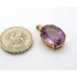 A 14ct gold pendant set with large facet cut amethyst CONDITION: Please Note - we