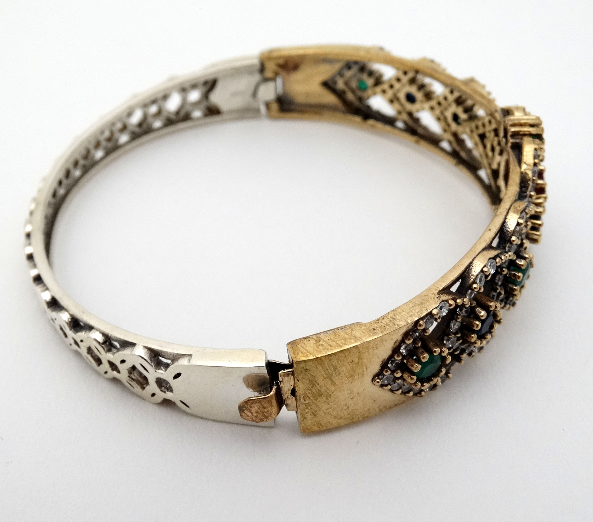 A silver bracelet of bangle form with gilt decoration and set with red blue and white stones - Image 5 of 5