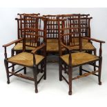 A set of 8 (6+2) Lancashire stained ash dining chairs with envelope rush seats.