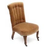 A Victorian walnut nursing chair with overstuffed upholstery 31" high CONDITION: