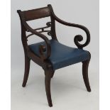 A Regency mahogany open arm / carver chair with sabre legs and drop in seats 32 1/2" high