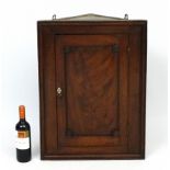 A Regency flame mahogany corner cupboard with single door 27 1/2" high x 20 1/2" wide