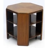Art Deco : A walnut octagonal revolving table with two undertiers on 4 feet / castors 24" x 24" x