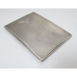 An Art Deco silver cigarette case with engine turned decoration.