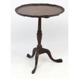 A charming Georgian tripod supper table with one piece mahogany top and carved decoration to legs