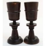 Treen a pair of Lignum vitae turned wooden goblets,