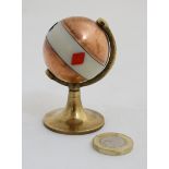 An early 20thC brass and copper Trump / playing card marker of globe form with ivorine banding and