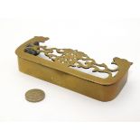 A 19thC tradesman / salesman's sample: A pierced cast brass miniature fire fender 1" high x 5 5/8"
