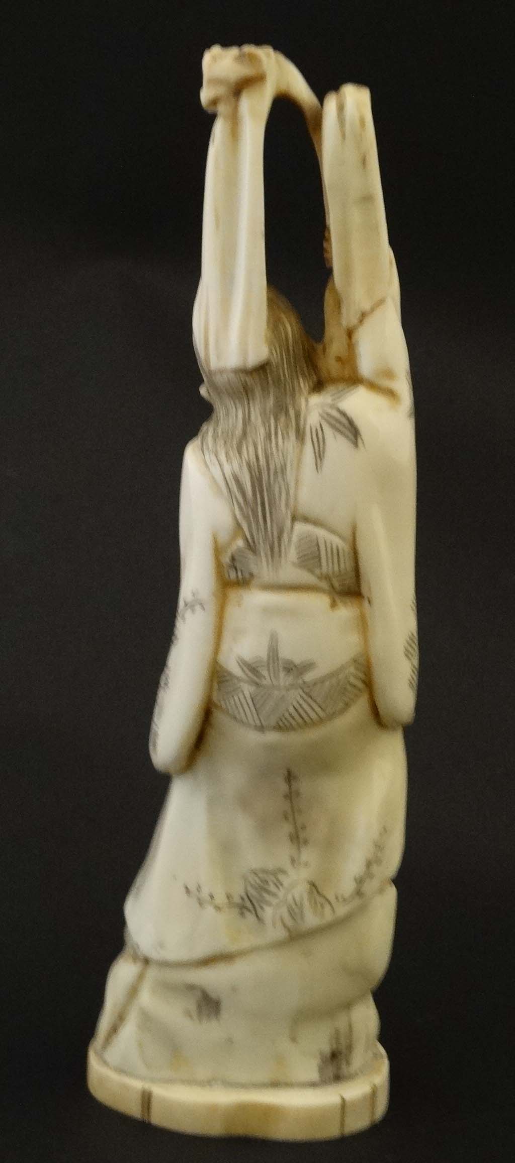 An Japanese ivory Meiji okimono formed as a figure standing with a gourd. Signed under. - Image 4 of 4