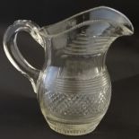 A 19thC cut glass jug with loop handle.