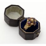 A yellow metal ring set with Almondine coloured Garnets and seed pearls. Maker J.