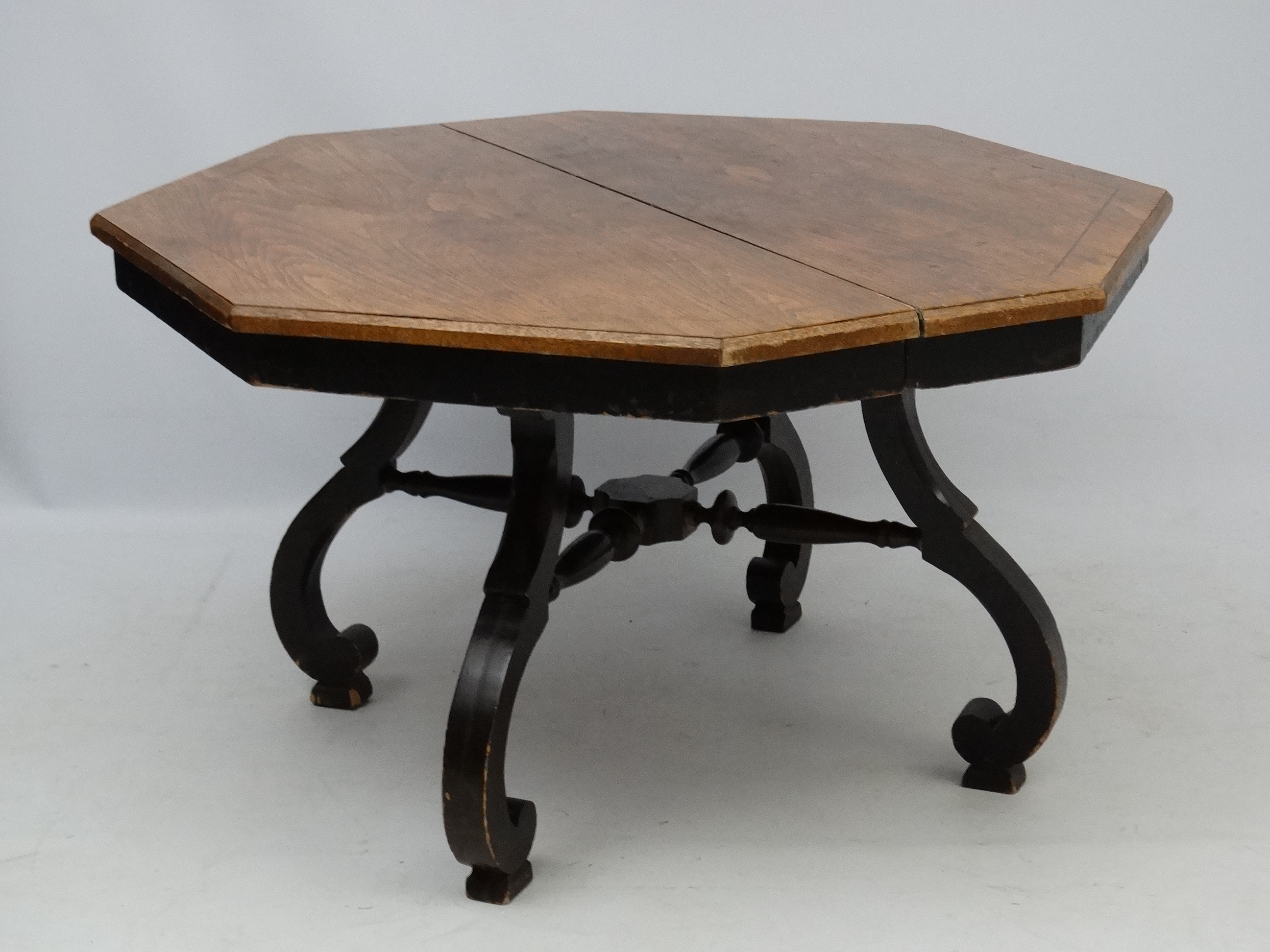 An early 20thC American octagonal oak topped four legged centre table with ebonised base, - Image 2 of 7