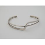 A silver bangle marked '925' CONDITION: Please Note - we do not make reference to