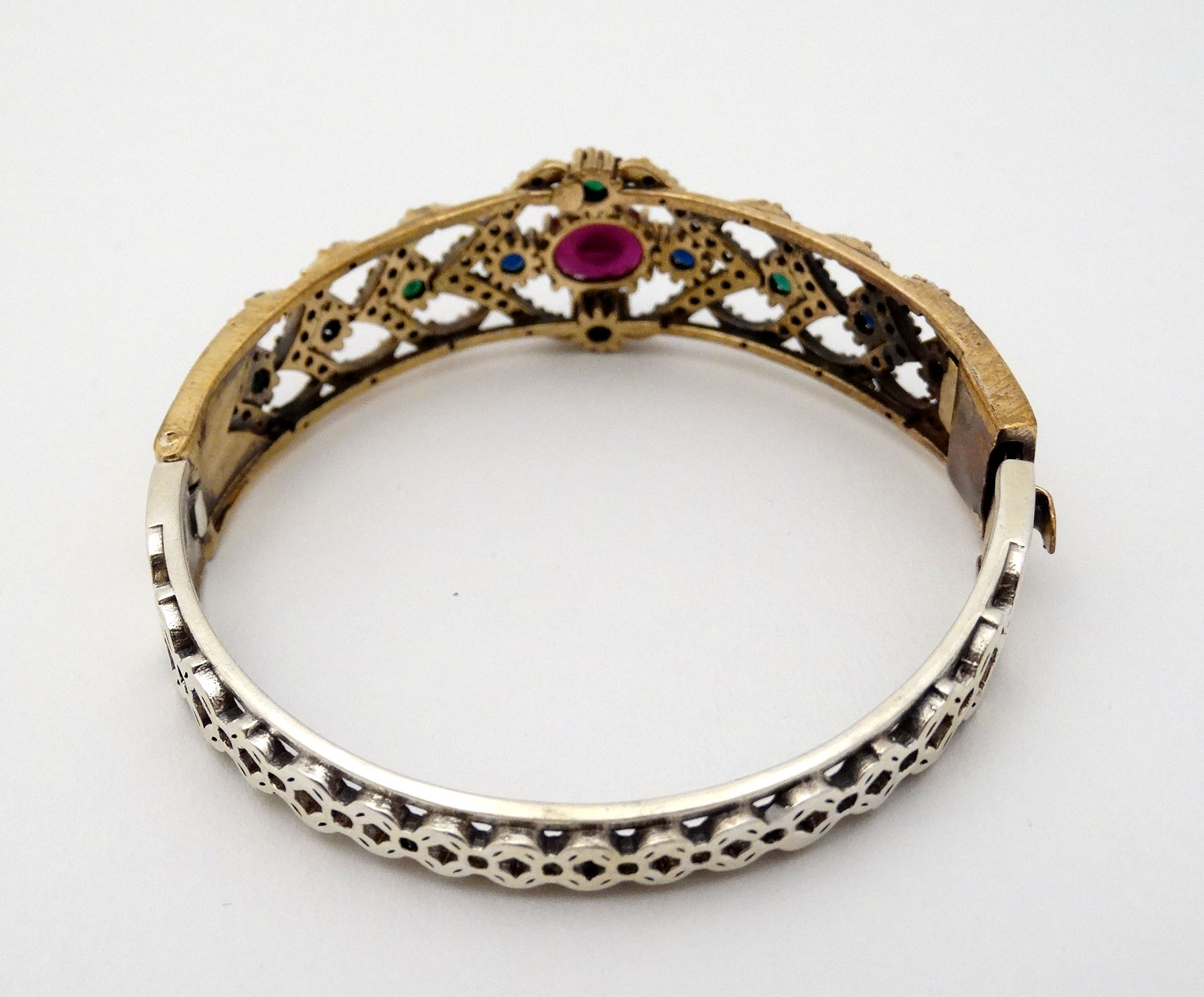 A silver bracelet of bangle form with gilt decoration and set with red blue and white stones - Image 4 of 5