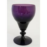 A 19thC amethyst glass wine glass. Approx 6" tall.