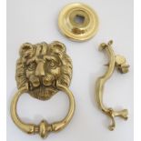 A late 20thC cast brass door knocker in the form of lions mask with ring.
