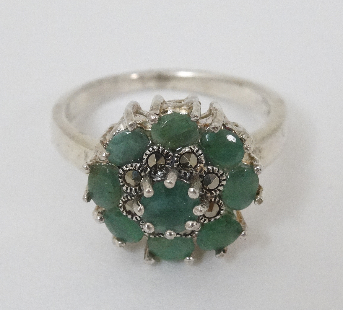 A silver ring set with green stones and marcasites CONDITION: Please Note - we do