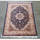 Carpet / Rug : A machine made blue Keshan rug with cream, blue black , mustard, etc colours ,