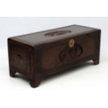 A Malaysian camphor wood blacked box with lift out tray and carved decoration 48" wide x 19 3/4"