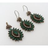 A pair of silver drop earrings set with green and white stones together with a matching pendant.