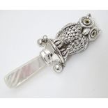 A novelty silver rattle formed as a owl with mother of pearl teether 3 1/2" long
