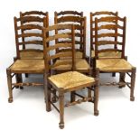 A set of 7 early 20thC oak ladder back dining chairs with envelope rush seats 39 1/2" high