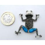 A silver pendant formed as a frog set with marcasite and turquoise 1 3/4" high