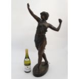 An early 20thC bronze effect figural lamp in the form of a maiden standing 31" high