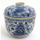 A Chinese blue and white pot and cover , decorated with flowers among scrolling foliage,