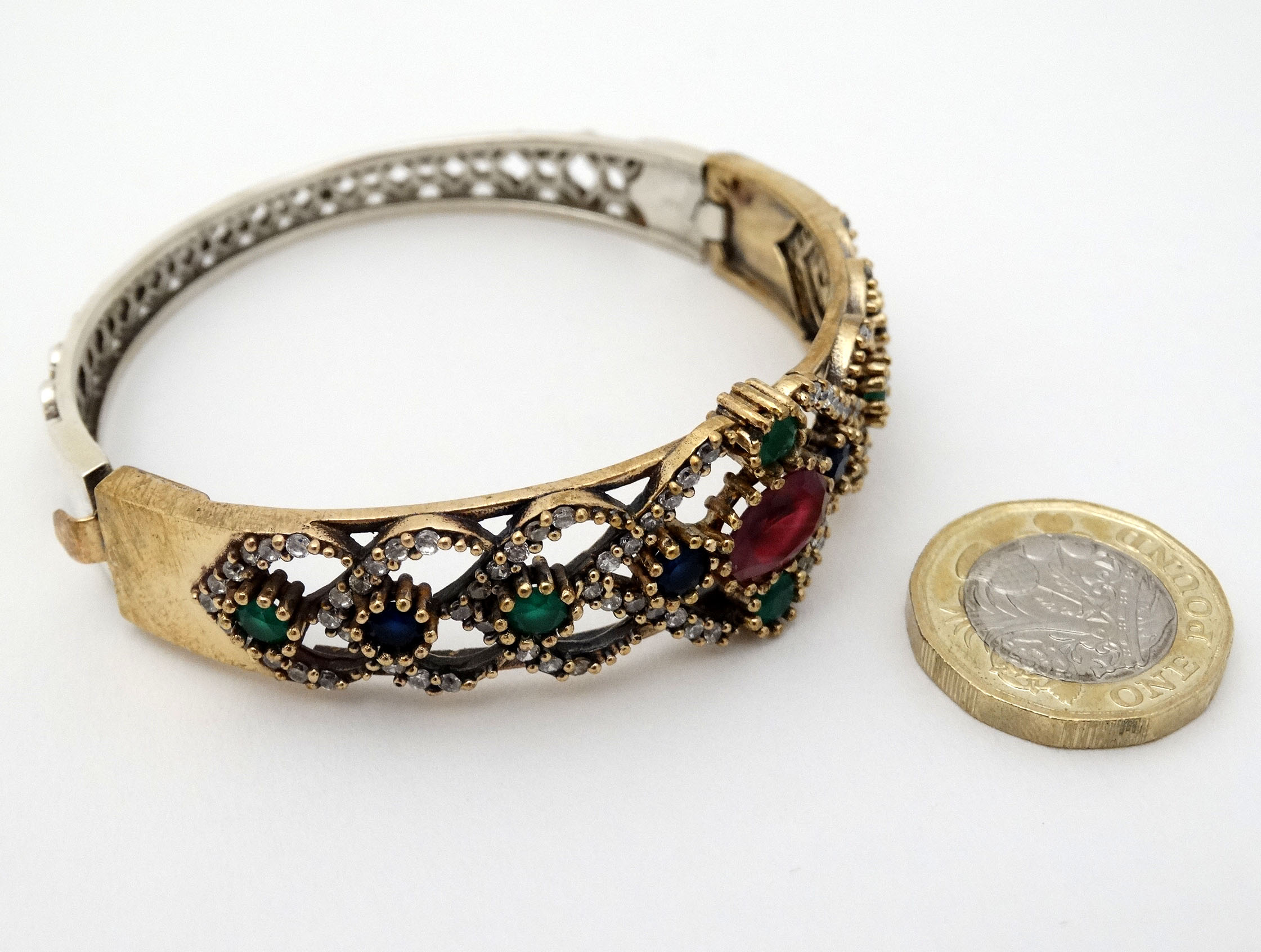 A silver bracelet of bangle form with gilt decoration and set with red blue and white stones - Image 3 of 5