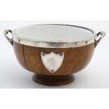 A 1920's oak and silverplate pedestal salad bowl with loop handles ,