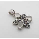 A silver pendant set with moonstones and sapphires 1" high CONDITION: Please Note -