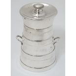A silver pepper mill / grinder formed as a milk churn.