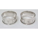 A pair of silver napkin rings with engine turned decoration hallmarked Birmingham 1933 maker Henry