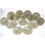 A collection of Continental Majolica Faience plates and side plates (7 +7) each decorated to centre