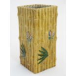 A Chinese vase decorated in relief with bamboo, palm leaves and butterflies,