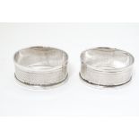 A pair of silver napkin rings with engine turned decoration hallmarked Birmingham 1933 maker Henry