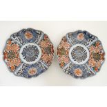 A pair of Japanese Imari plates having decorative floral and foliate panels with central medallions