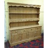 A 20thC Victorian style stripped pine kitchen dresser 75" wide x 77" high x 17" deep