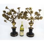 A pair of 19thC ornate brass candelabra formed as Chippendale Revival urns with floral sprigs each