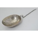 A white metal spoon / bowl / vessel with wrigglework decoration.