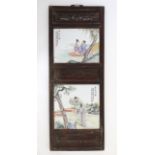 A Chinese hanging screen formed of two famille rose ceramic panels in wooden frame,