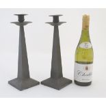 Decorative Metalware : A pair of pewter candlesticks of squared tapering form with plannished